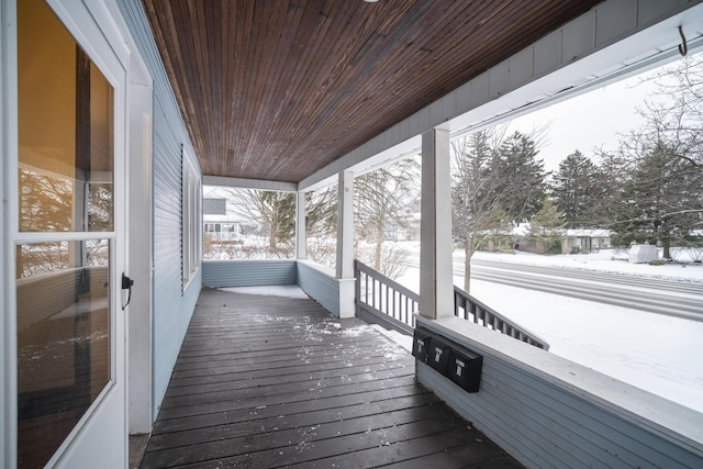 snow covered deck with covered porch