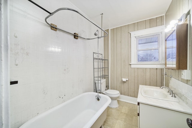 full bathroom with toilet, wooden walls, bathing tub / shower combination, and vanity