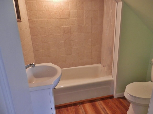 full bathroom featuring toilet, vanity, hardwood / wood-style floors, and  shower combination