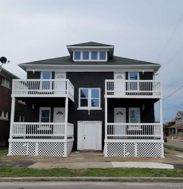 view of front of home with covered porch and a balcony