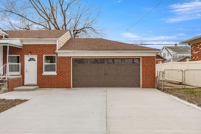 view of front facade featuring fence, roof with shingles, an attached garage, brick siding, and concrete driveway