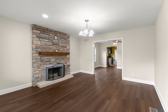 unfurnished living room with a fireplace, an inviting chandelier, and dark hardwood / wood-style floors