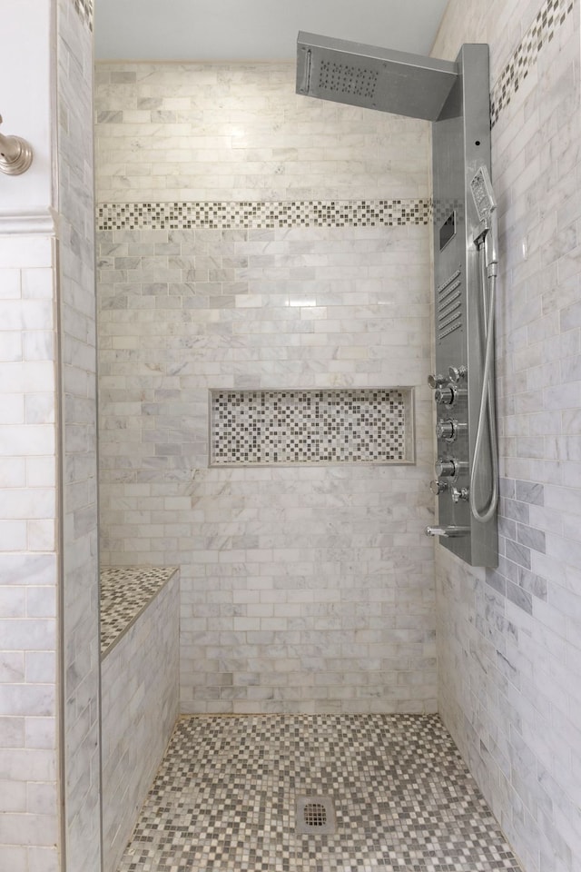 full bath featuring tiled shower