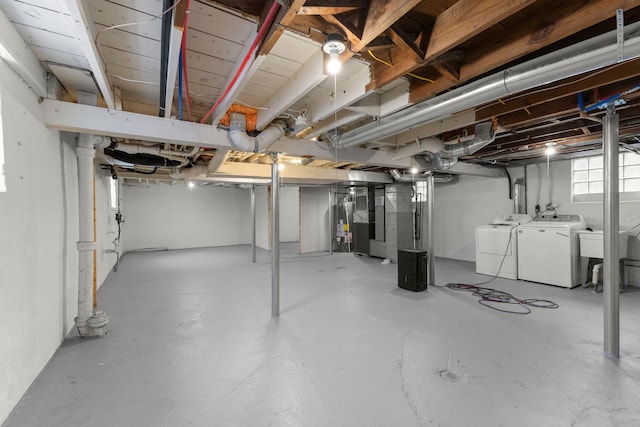 basement featuring washing machine and clothes dryer and gas water heater