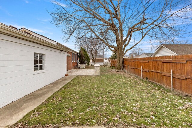 view of yard with a fenced backyard and a patio area