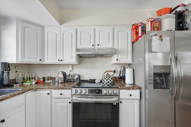 kitchen featuring tile patterned floors, white cabinetry, appliances with stainless steel finishes, and dark stone counters