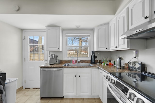 kitchen featuring white cabinets, appliances with stainless steel finishes, sink, and light tile patterned flooring