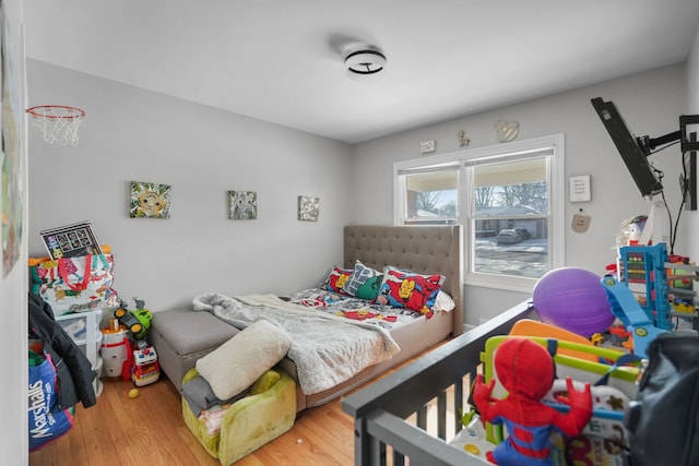 bedroom with hardwood / wood-style flooring