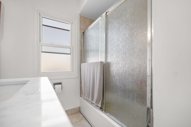 bathroom featuring bath / shower combo with glass door, tile patterned floors, and vanity