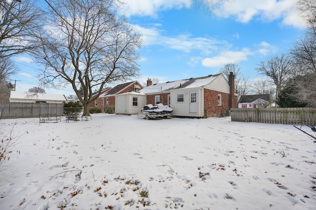 snow covered house with a shed