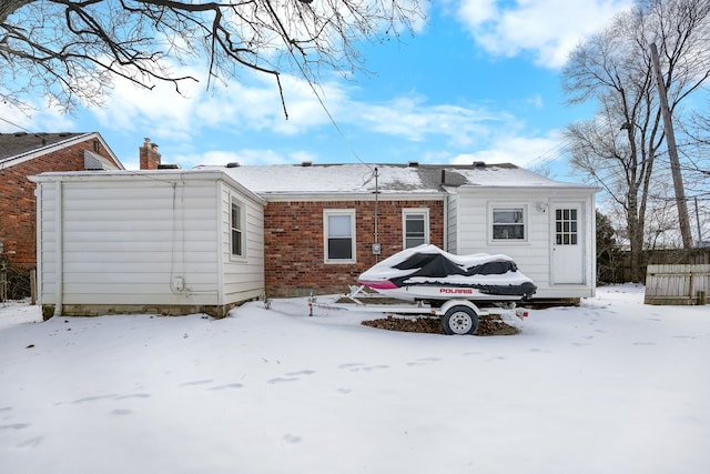 view of snow covered rear of property