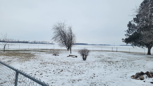 yard layered in snow with a rural view