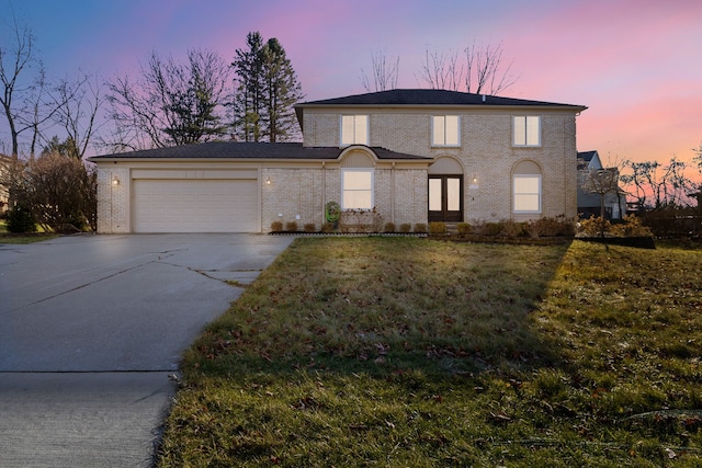 view of front of property with a yard and a garage