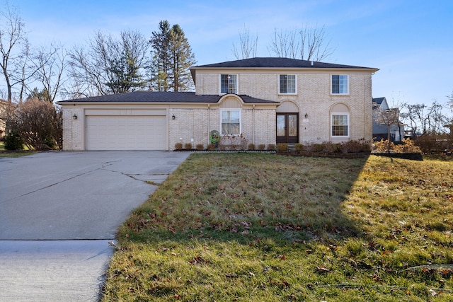 view of front of property with a front lawn and a garage