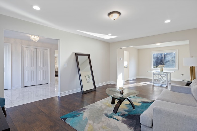 living room featuring an inviting chandelier and hardwood / wood-style floors