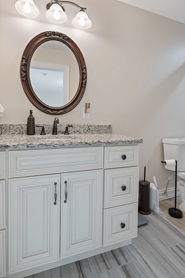 bathroom with toilet and vanity