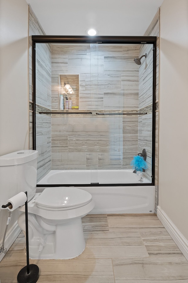 bathroom with toilet and enclosed tub / shower combo