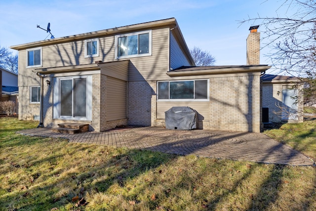 rear view of house featuring a patio area and a yard