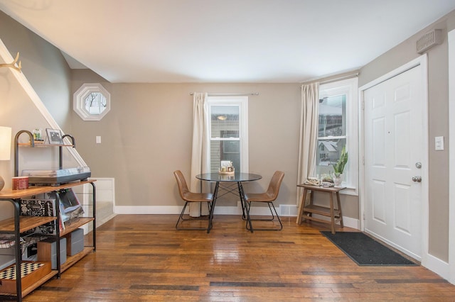 dining area with dark wood-type flooring