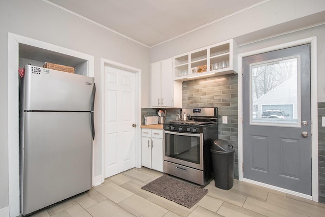 kitchen featuring white cabinets, appliances with stainless steel finishes, and tasteful backsplash