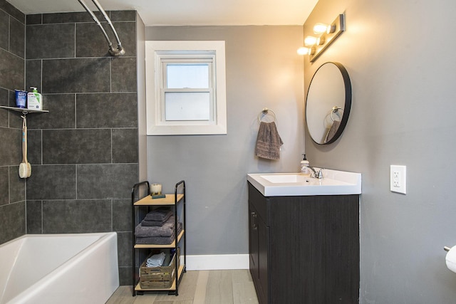 bathroom with vanity and tiled shower / bath