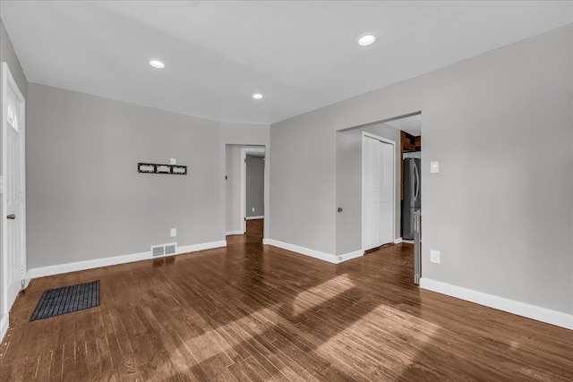 spare room with dark wood-type flooring