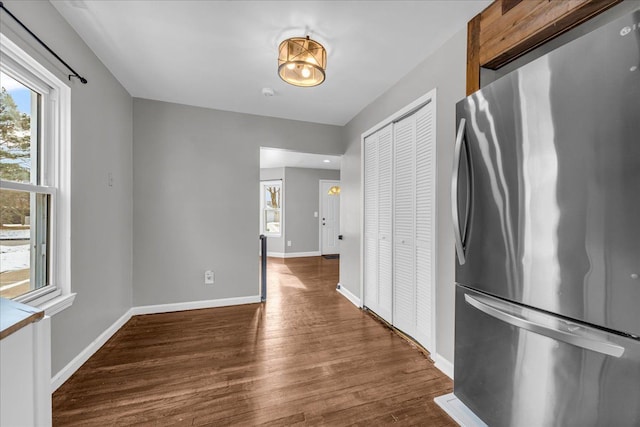 kitchen with stainless steel fridge and dark hardwood / wood-style flooring