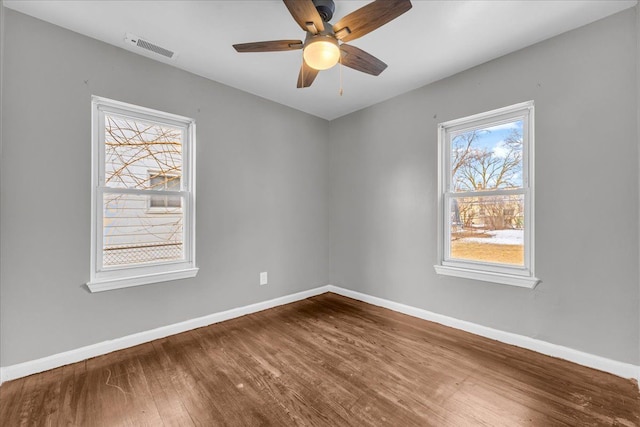 spare room with ceiling fan and wood-type flooring