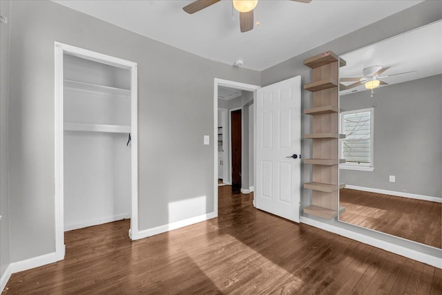 unfurnished bedroom featuring dark hardwood / wood-style floors, ceiling fan, and a closet