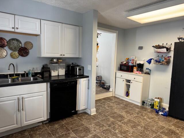 kitchen with sink, black appliances, and white cabinetry