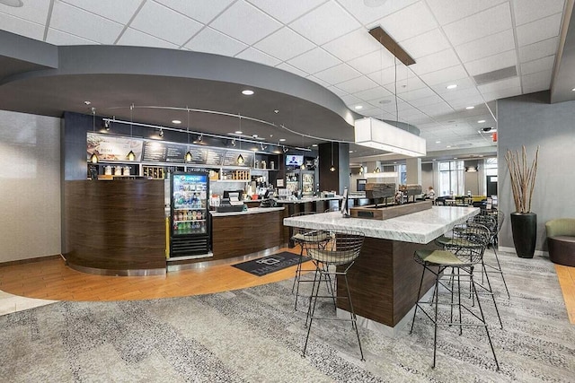 interior space with light stone counters, light hardwood / wood-style flooring, and dark brown cabinetry