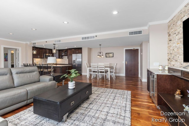 living room with ornamental molding and dark hardwood / wood-style floors