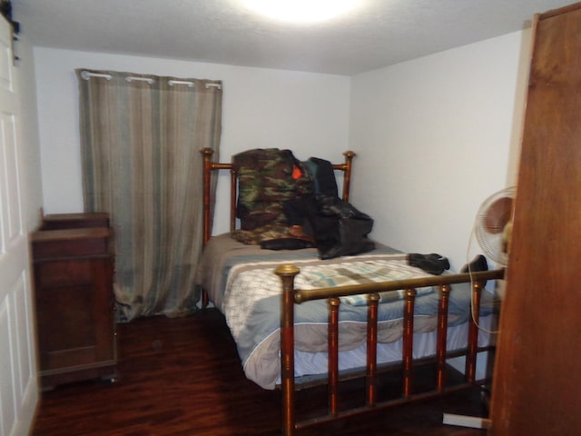 bedroom featuring dark hardwood / wood-style floors