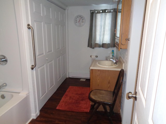 bathroom with hardwood / wood-style flooring, shower / bathing tub combination, and vanity