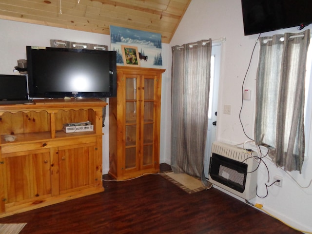 living room with lofted ceiling, heating unit, and dark hardwood / wood-style flooring