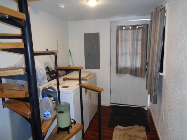 laundry room with electric panel, washer and clothes dryer, and dark hardwood / wood-style flooring