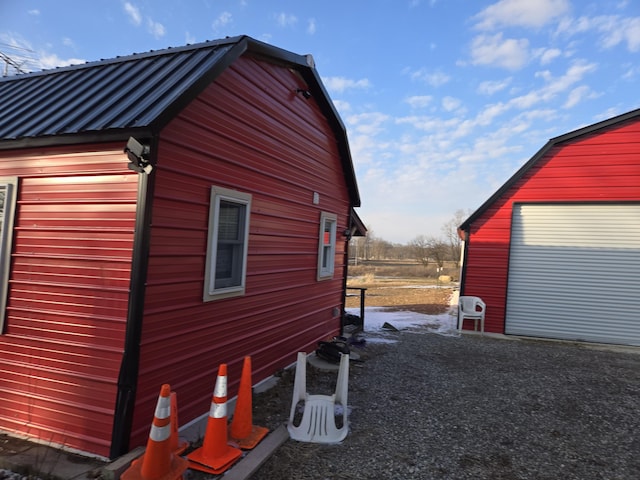 view of side of property with a garage and an outdoor structure