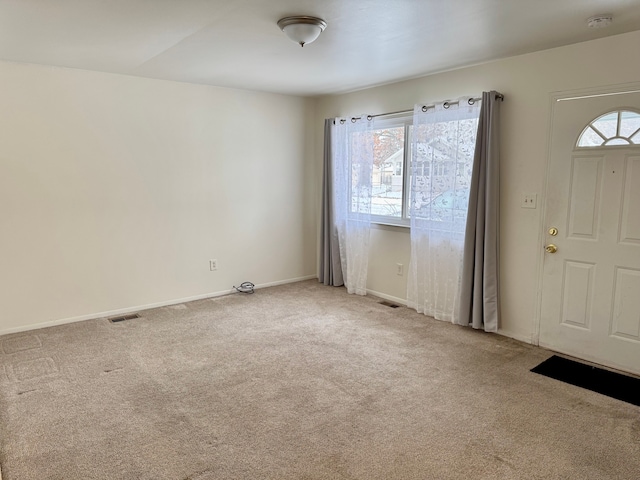 view of carpeted foyer entrance