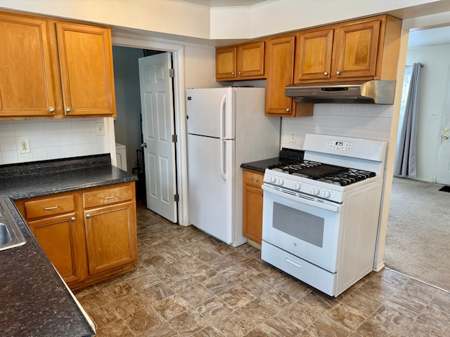 kitchen featuring white appliances, sink, carpet, and tasteful backsplash