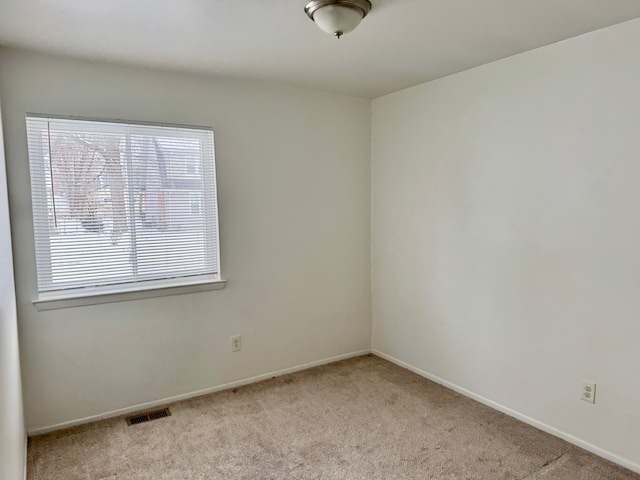 spare room with light colored carpet