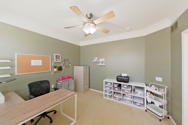 carpeted office featuring ornamental molding and ceiling fan