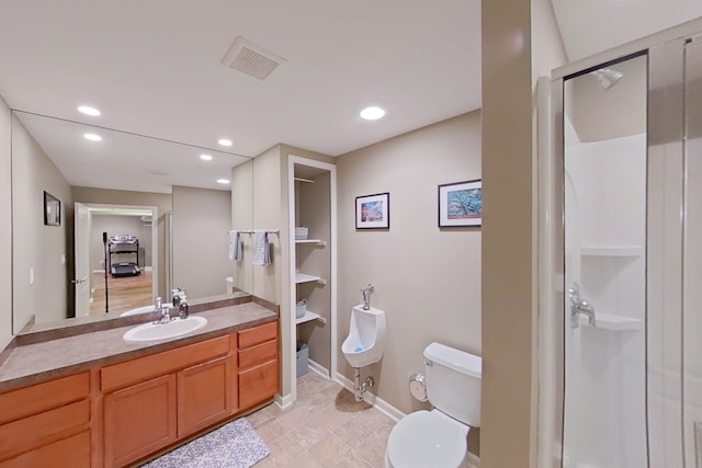 bathroom with vanity, a shower with shower door, and toilet