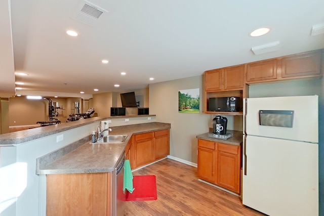 kitchen featuring sink, white refrigerator, light hardwood / wood-style floors, stainless steel dishwasher, and kitchen peninsula