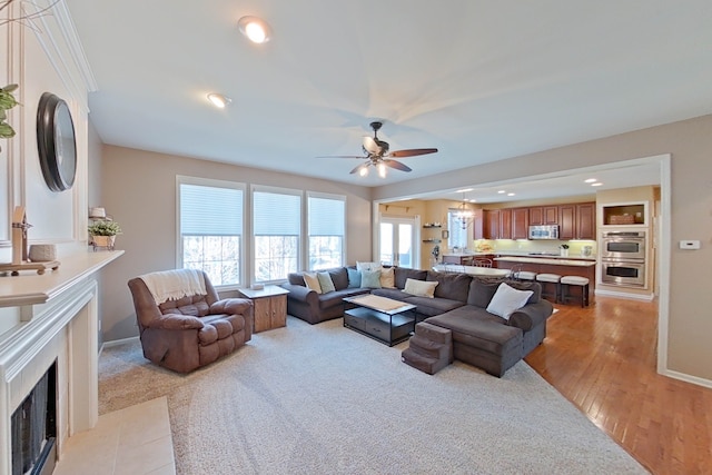 living room with light hardwood / wood-style floors and ceiling fan