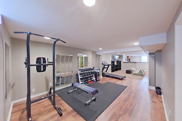 exercise room with light hardwood / wood-style flooring