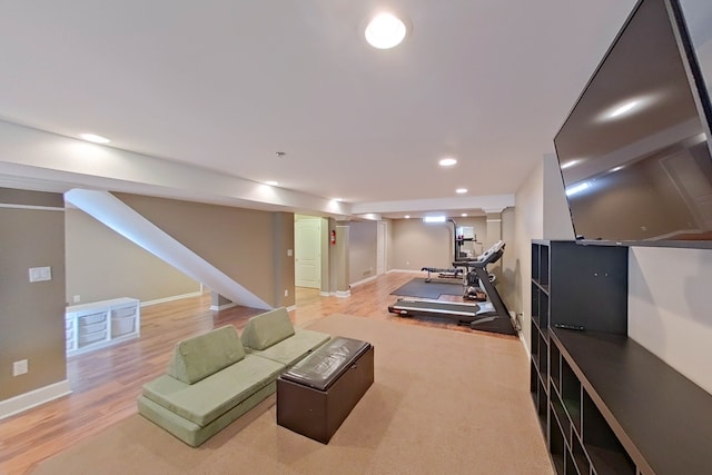 workout room with light hardwood / wood-style floors