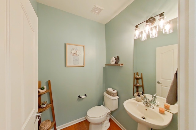 bathroom featuring sink, hardwood / wood-style flooring, and toilet