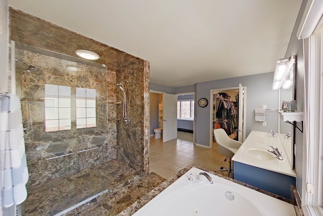 bathroom featuring vanity, tile patterned floors, and plus walk in shower