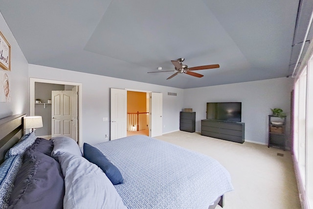 bedroom featuring light carpet and ceiling fan