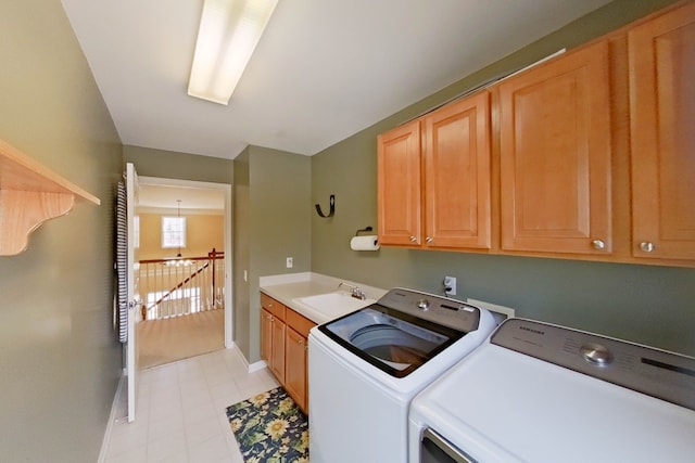 laundry room featuring cabinets, sink, and washer and dryer